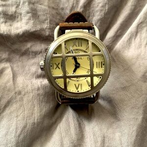 Brown fossil watch with a steel cage cover
